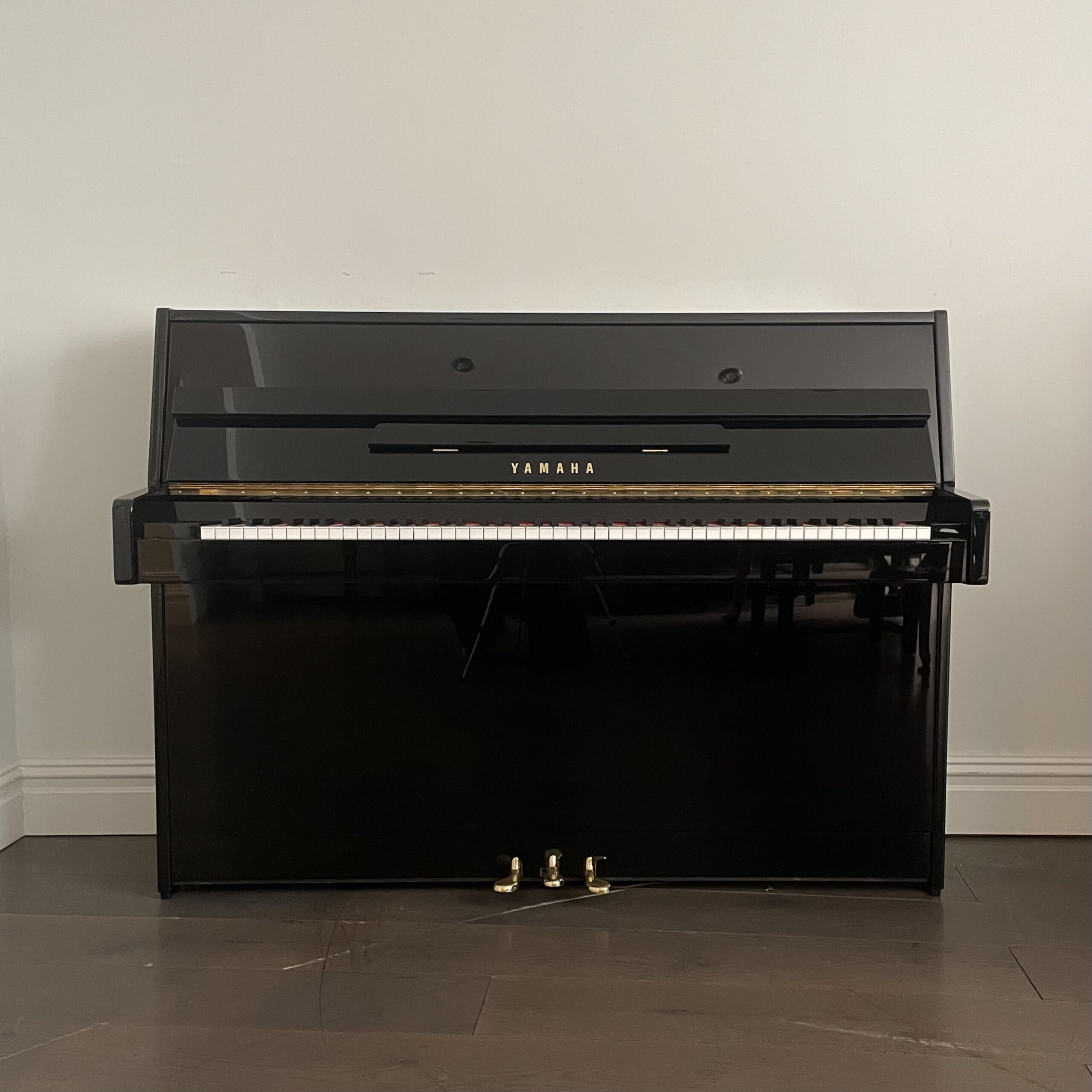 A Yamaha C110 Upright Piano